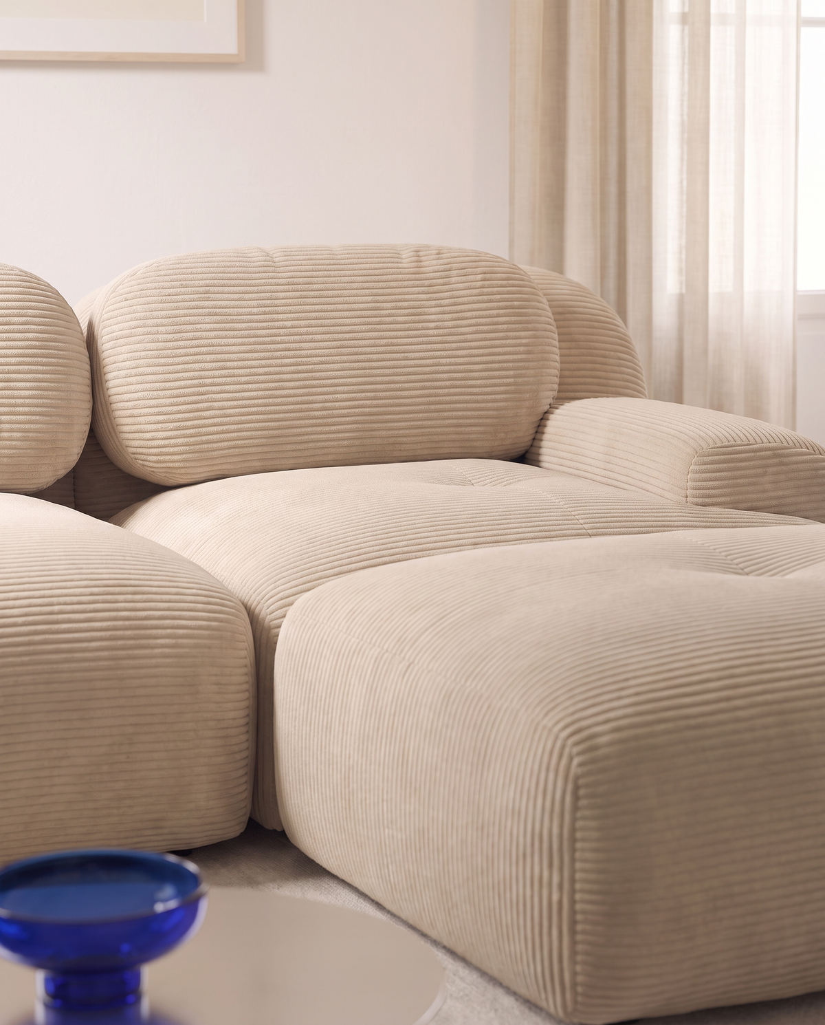Détail du pouf méridienne du canapé d'angle Crique en velours côtelé blanc cassé